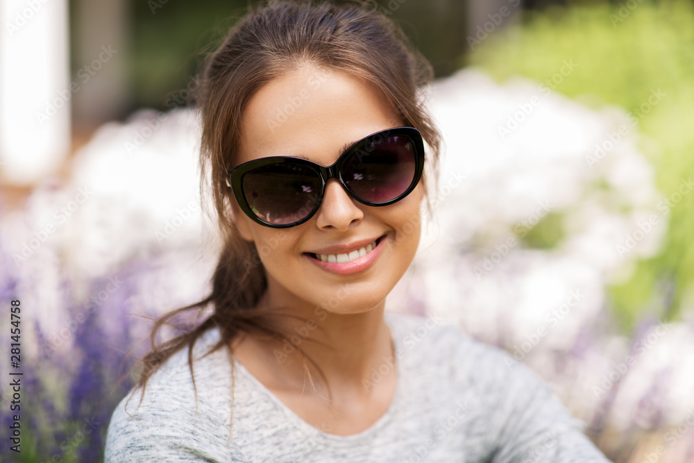 summertime, leisure and people concept - portrait of happy young woman in sunglasses at summer garden summertime, leisure and people concept - portrait of happy young woman in sunglasses at summer garden