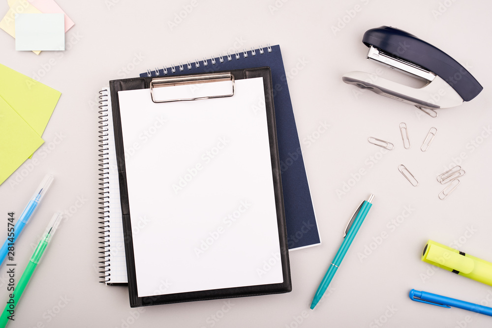 Planner on the grey wooden working table. Blank white paper on working desk Planner on the grey wooden working table. Blank white paper on working desk