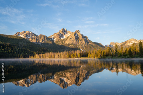 Sunrise at Stanley Lake with Sawtooth Mountains reflecting in the calm water