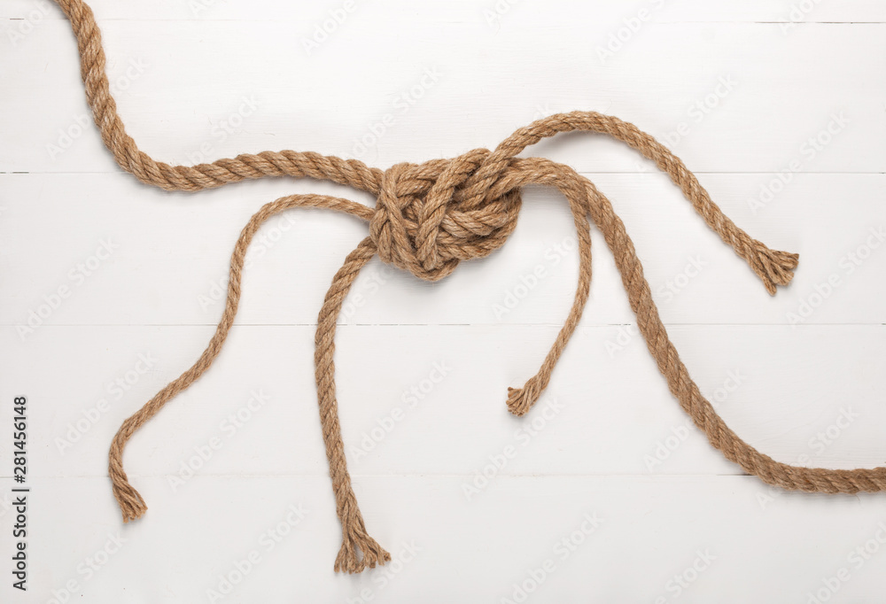 Jute rope on white wooden background.