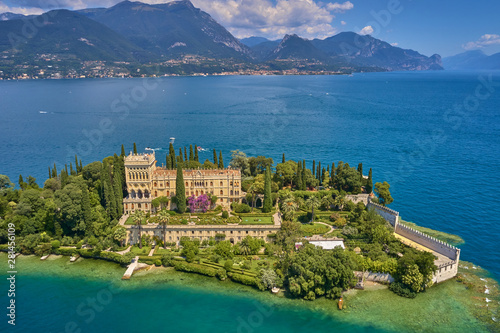 Unique view of the island of Garda. In the background is the Alps. Resort place on Lake Garda north of Italy. Aerial photography.