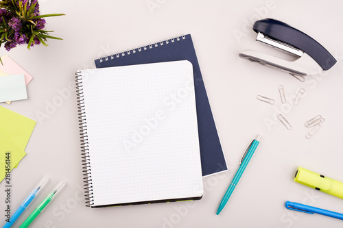 Planner on the grey wooden working table. Blank white paper on working desk