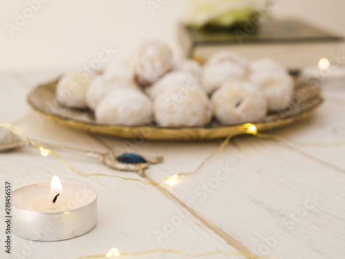 Defocused cookie plate with candle and quran