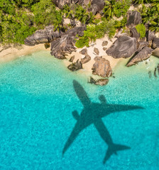 Travel concept with airplane shadow and beach