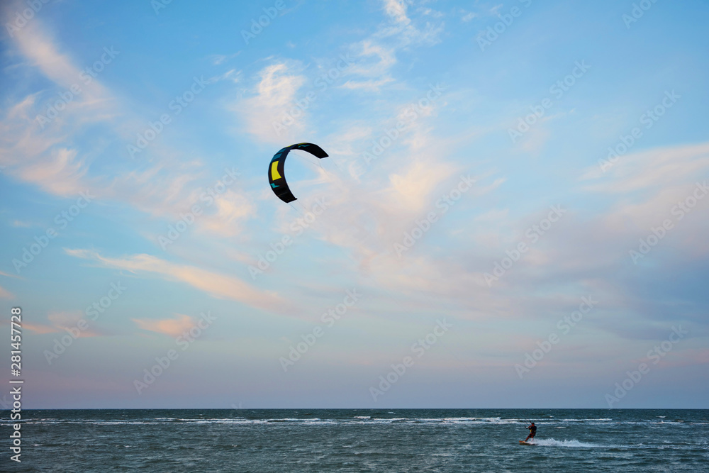 a surfer kite surfing the waves a surfer kite surfing the waves