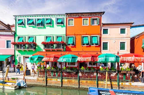 bright colorful picturesque buildings near a chanel of Venice , houses of Burano in the evening