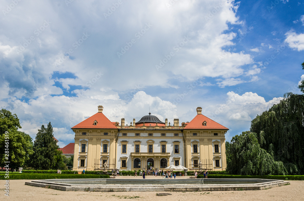 Castle in Slavkov with a fountain and blue sky in the background