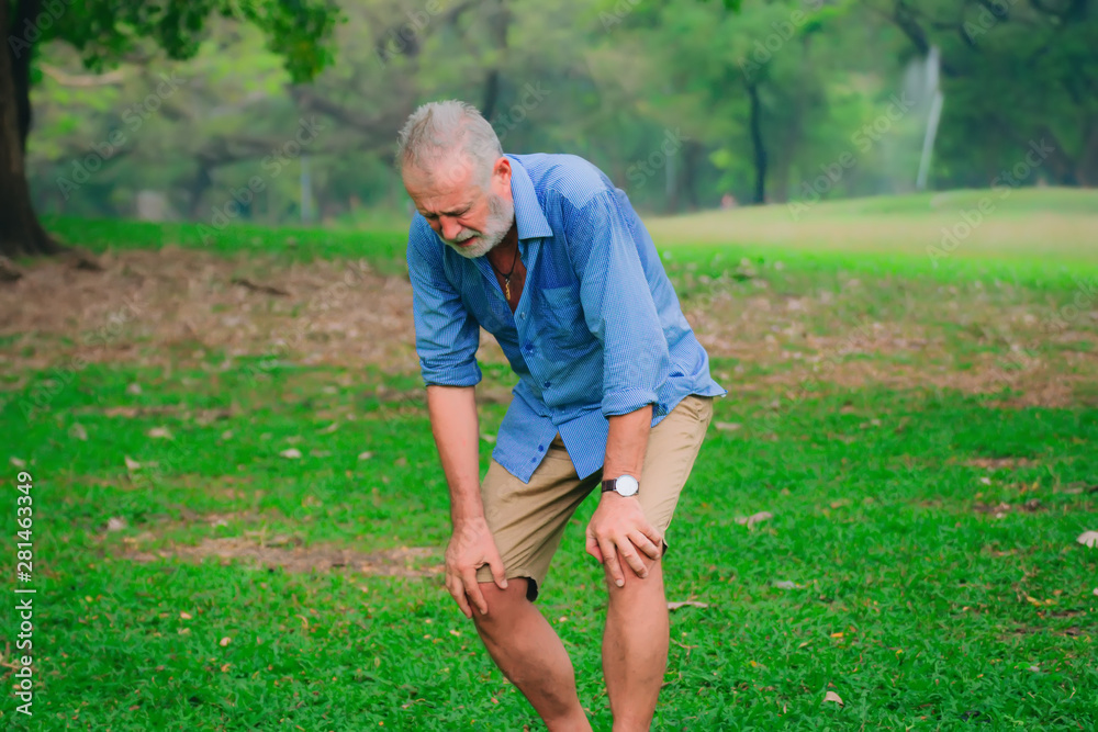 retirees man having knee pain in park,after him exercise. retirees man having knee pain in park,after him exercise.