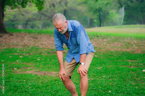 retirees man having knee pain in park,after him exercise. 