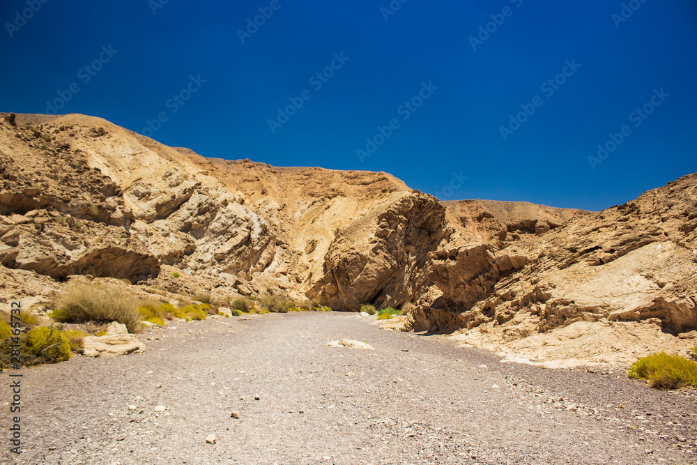 Israeli famous touristic heritage national park Red canyon scenic view path way between bare stone rocks 
