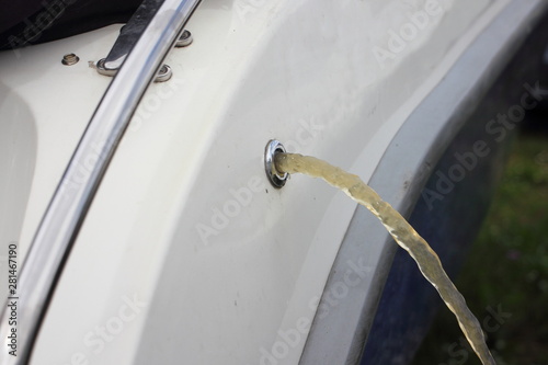 Vessel bilge pump removes water from boat through drain scupper in Board photo