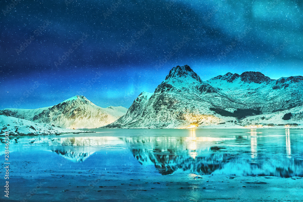 Amazing scene of Northern Lights (Aurora Polaris) on Lofoten Islands in Norway. Beautiful colorful landscape of polar lights on starry sky reflected in the fjord on Lofotens.
