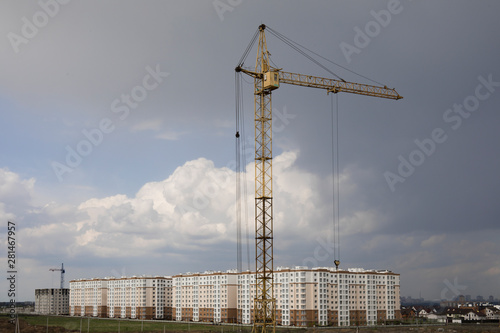Industrial construction building crane and new houses