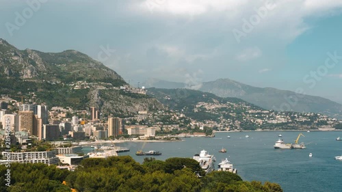 Monaco. Cote d'Azur, expensive resort, rest. The sun is shining. Trees and mountains in the fog.