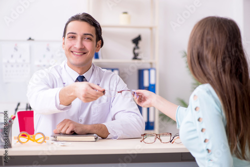 Young woman visiting male doctor oculist