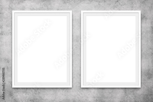 two blank picture frames hanging on concrete wall, mock-up -