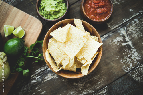 Chips with Salsa and Guacamole over Wooden Table