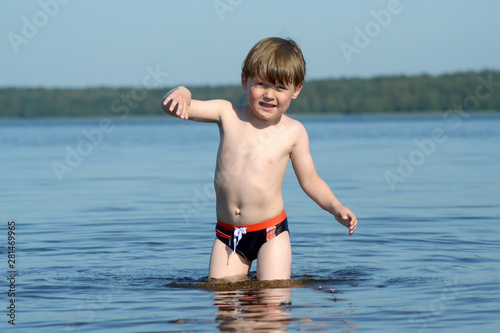 Little boy swimming in the lake