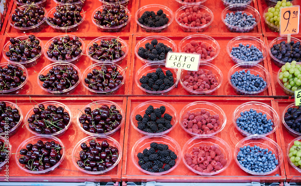 Raspberries, blueberries, cherries is for sale in The square of the hay market Raspberries, blueberries, cherries is for sale in The square of the hay market