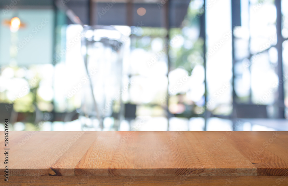 Wooden table with Blurred of coffee's shop for abstract background Wooden table with Blurred of coffee's shop for abstract background