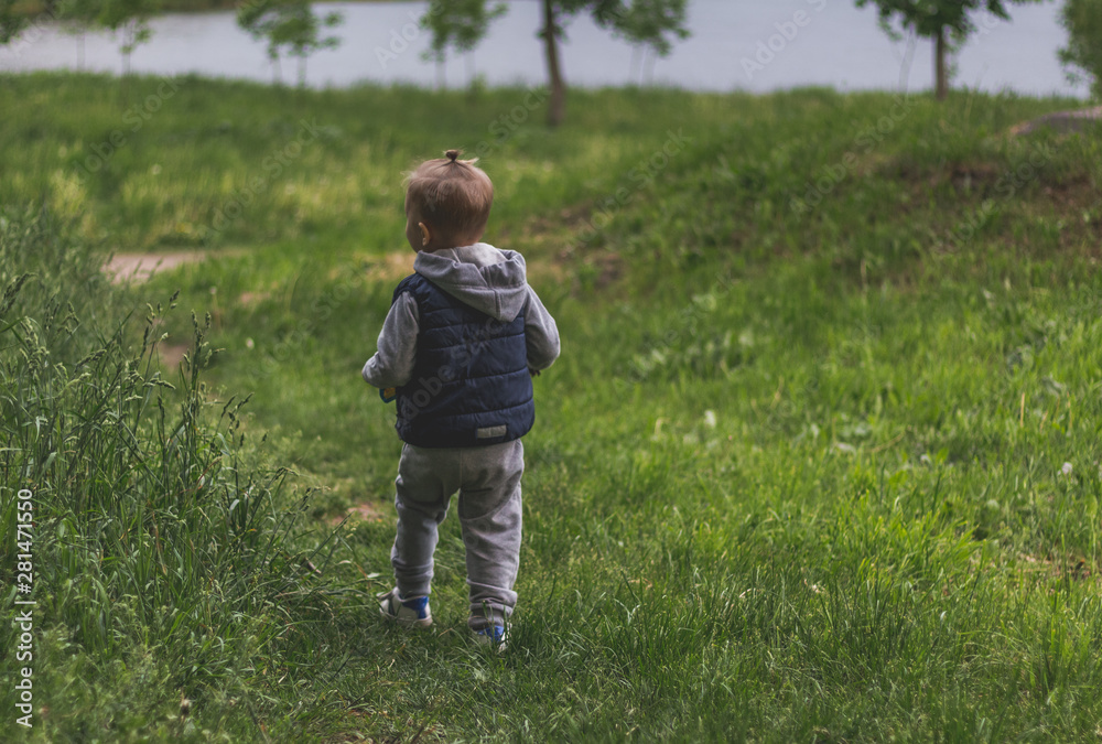Trendy little traveller in sportswear explores Park Trendy little traveller in sportswear explores Park