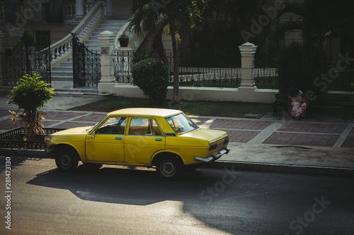 an old yellow car parked