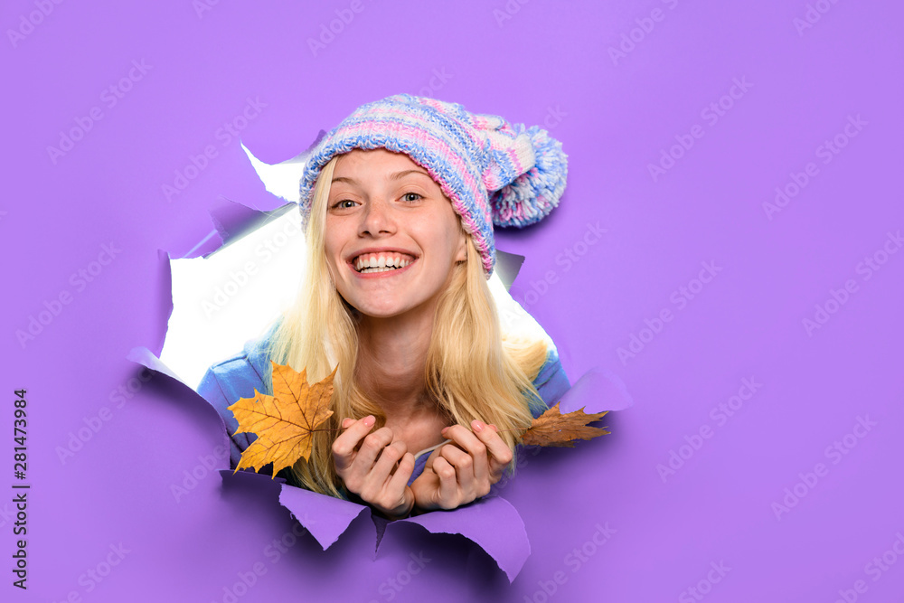 Happy girl in hat with maple leaves. Happy girl holds leaf. Autumn sales. Autumnal mood. Yellow maple leaf. Discount. Sales. Smiling woman with autumn leaves looking through paper hole. Copy space. Happy girl in hat with maple leaves. Happy girl holds leaf. Autumn sales. Autumnal mood. Yellow maple leaf. Discount. Sales. Smiling woman with autumn leaves looking through paper hole. Copy space.