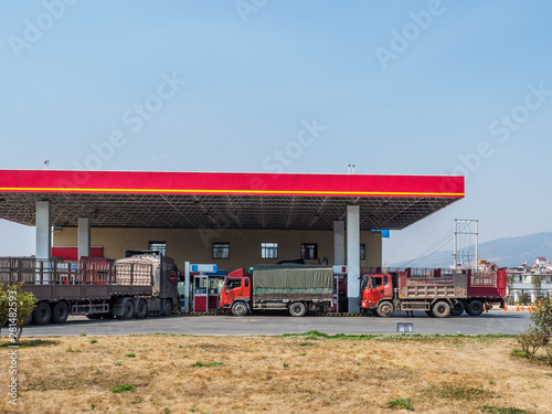 Photography Trucks are stopping at a Gas Station in a small village near Kunming in Yunnan Province (China)