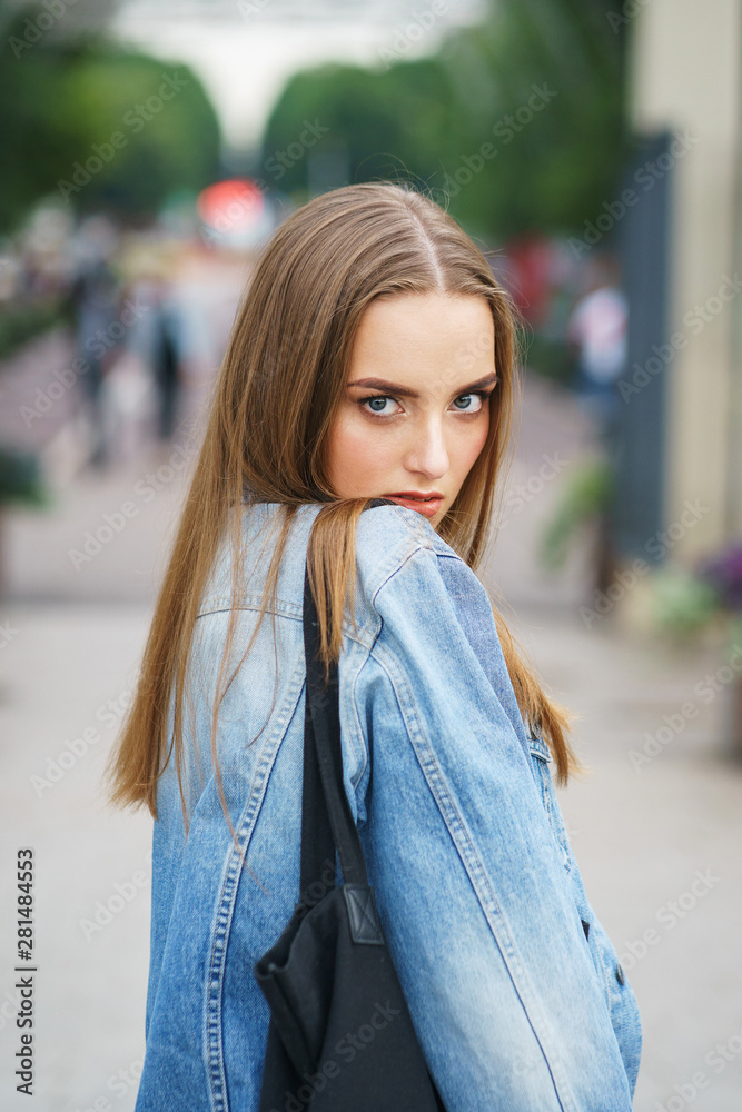 Beautiful model in fashionable clothes in the city park.