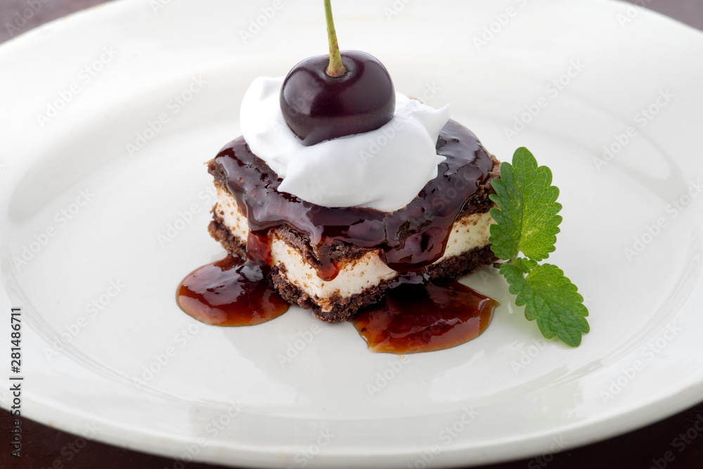waffle cake with cherry and whipped cream with mint leaf on white plate waffle cake with cherry and whipped cream with mint leaf on white plate