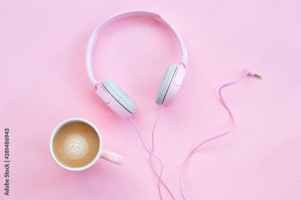 Pink headphones and coffee cup on a pink background. Music concept Pink headphones and coffee cup on a pink background. Music concept