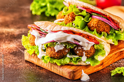 Falafel and fresh vegetables in pita bread.