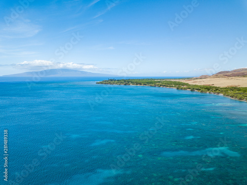 Drone side view of the dry mountains and crystal clear waters of the Lahaina Coast on the island of Maui, Hawaii © JLauer