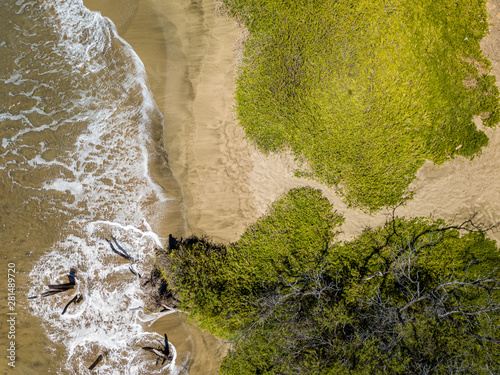 Drone top down view of the crystal clear water, crashing waves, and natural beachs of the Lahaina Coast on the island of Maui, Hawaii