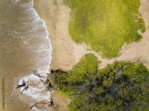 Drone top down view of the crystal clear water, crashing waves, and natural beachs of the Lahaina Coast on the island of Maui, Hawaii photo