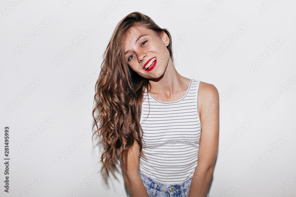CLose up portrait happy woman with long wavy hair with red lips looking at camera with smile over isolated background CLose up portrait happy woman with long wavy hair with red lips looking at camera with smile over isolated background