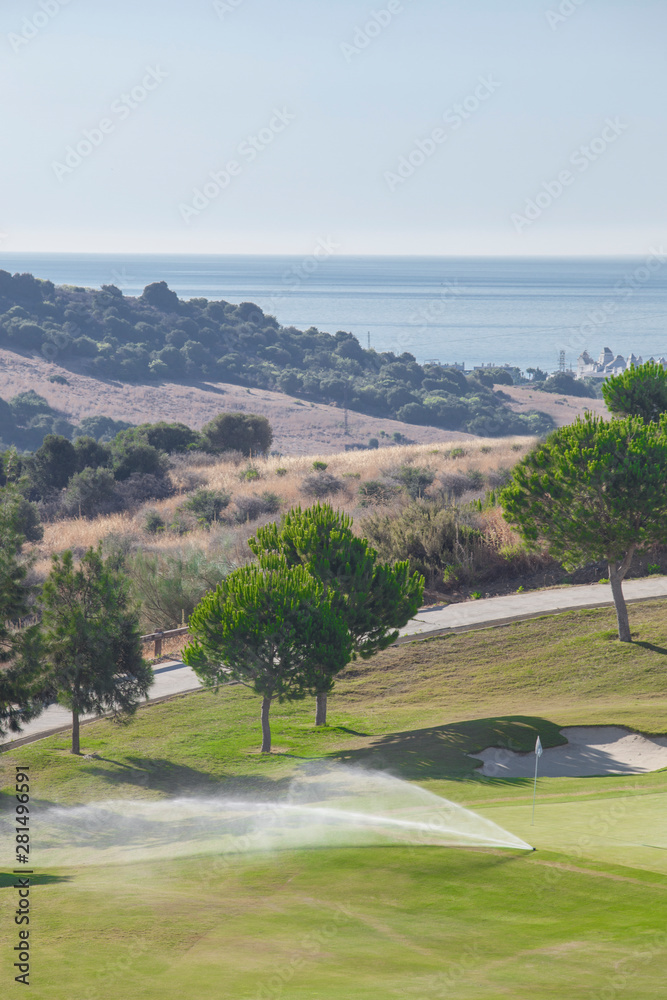 Watering system working on green golf course. Costa del Sol, Spain