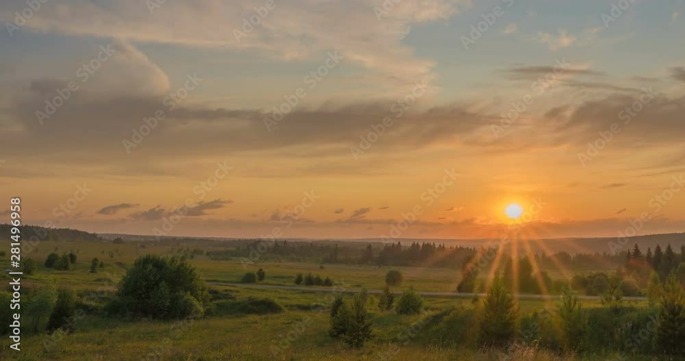 Beautiful evening sunset landscape with a span of time, forest and river in the distance Beautiful evening sunset landscape with a span of time, forest and river in the distance
