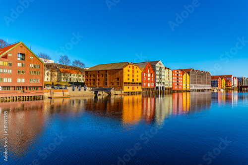 Colorful timber houses surrounding river Nidelva in the Brygge district of Trondheim, Norway photo