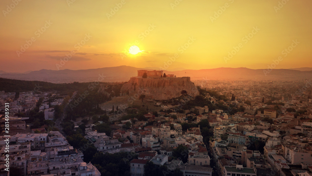 Aerial drone photo of iconic Acropolis hill and the unique masterpiece of Ancient world the Parthenon at sunset with beautiful golden colours, Athens historic centre, Attica, Greece