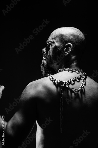 black and white portrait of a brutal man tearing the chain © Igor Sheremet