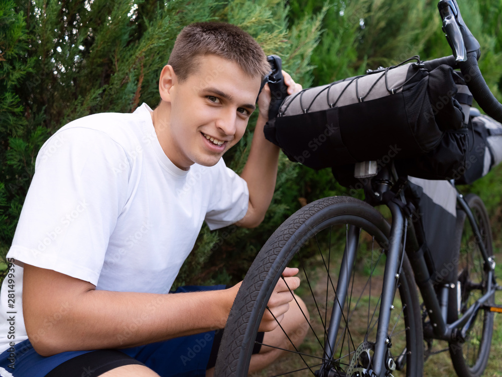 Teen boy prepares to ride a sports bike. Healthy lifestyle. Tourism. Sport.