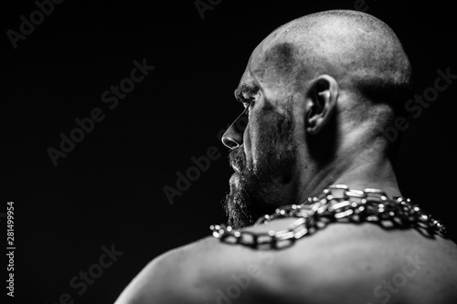 black and white portrait of a brutal man tearing the chain