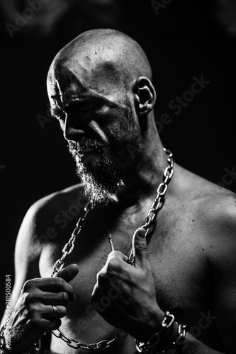 black and white portrait of a brutal man tearing the chain © Igor Sheremet