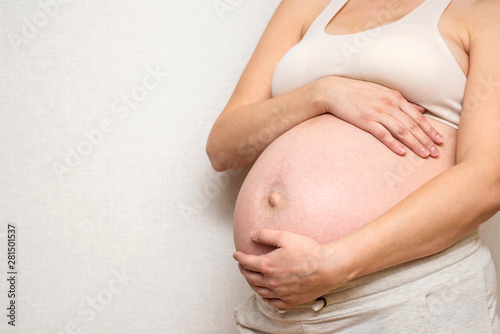 Close up of pregnant belly. Pregnant woman in white underwear. Young woman expecting a baby