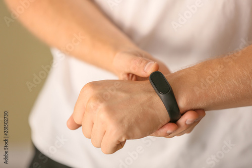 Man with fitness tracker checking his pulse  closeup