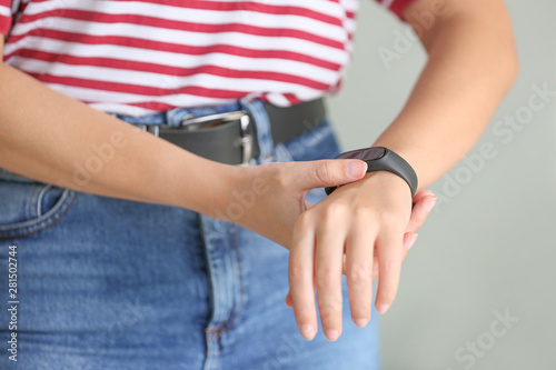 Woman with fitness tracker checking her pulse  closeup