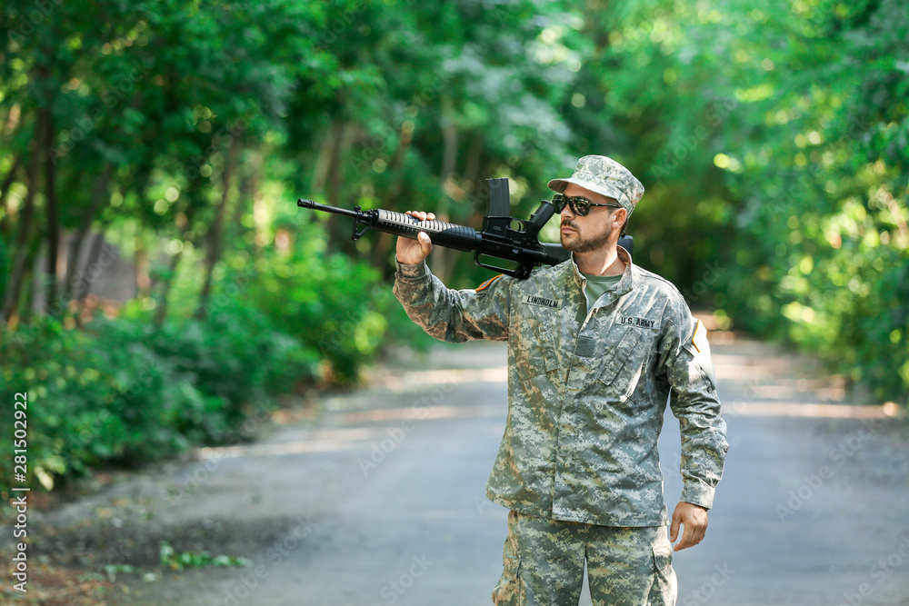 Soldier with assault rifle outdoors Soldier with assault rifle outdoors