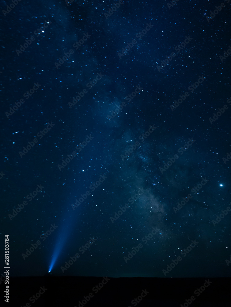Torch light pointing to the Milky Way - Gobi Desert, Mongolia Torch light pointing to the Milky Way - Gobi Desert, Mongolia