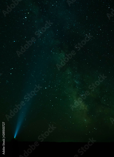 Torch light pointing to the Milky Way - Gobi Desert, Mongolia